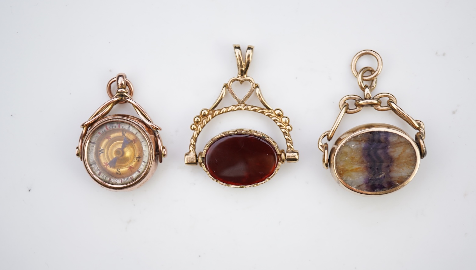 Three 9ct gold fob pendants